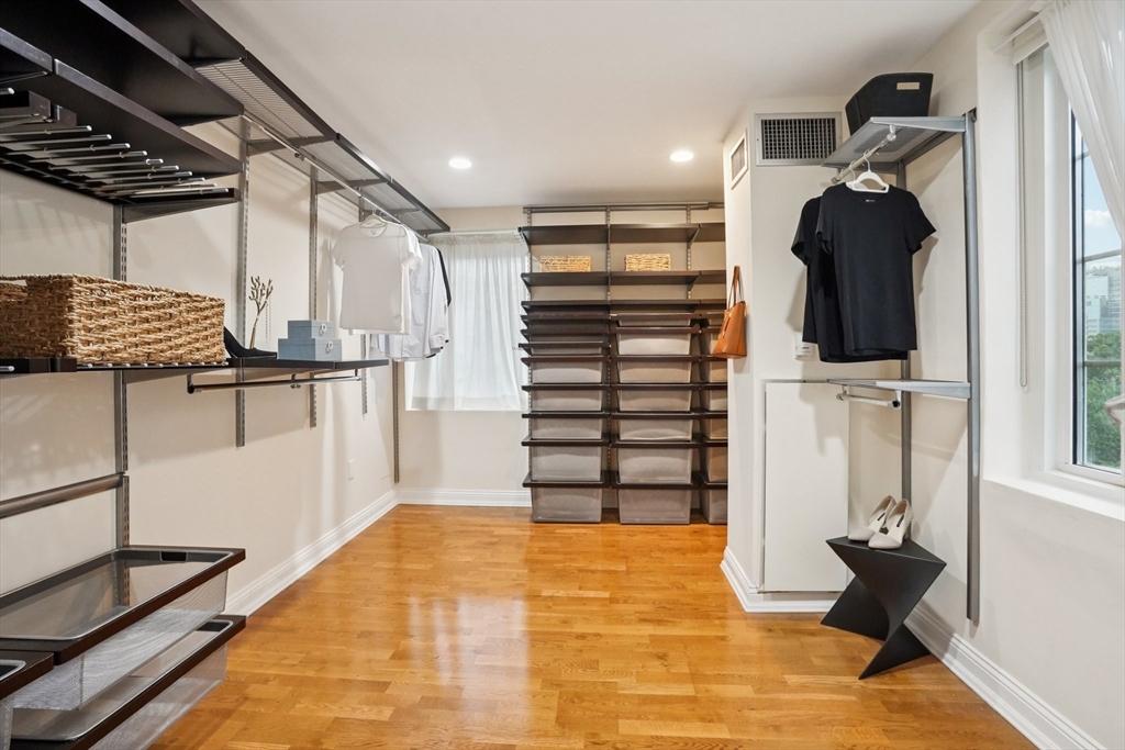 20 Chapel Street, Unit B811 Brookline, MA 02446 - Photo 9 of 33 a view of walk in closet with clothes and shoes