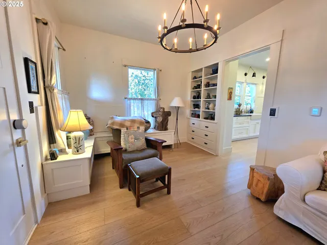 a living room with furniture and a chandelier