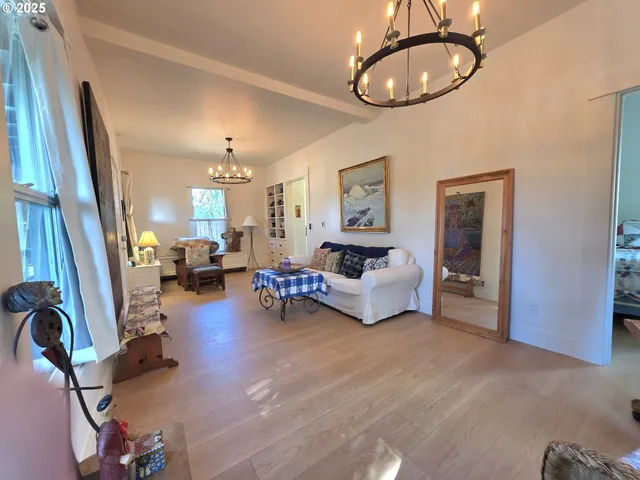a living room with furniture and a chandelier