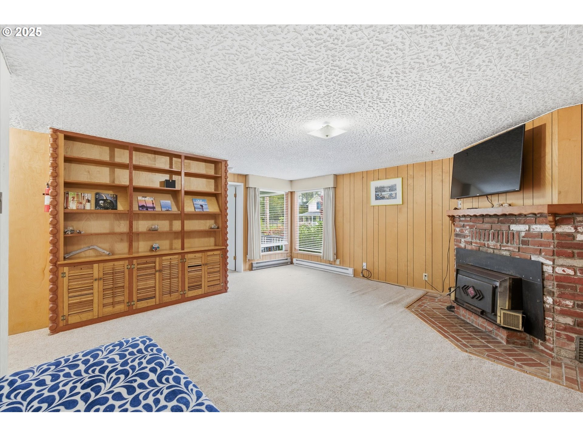 4514 L Place Seaview, WA 98644 - Photo 17 of 47 a view of an empty room with a fireplace and a window