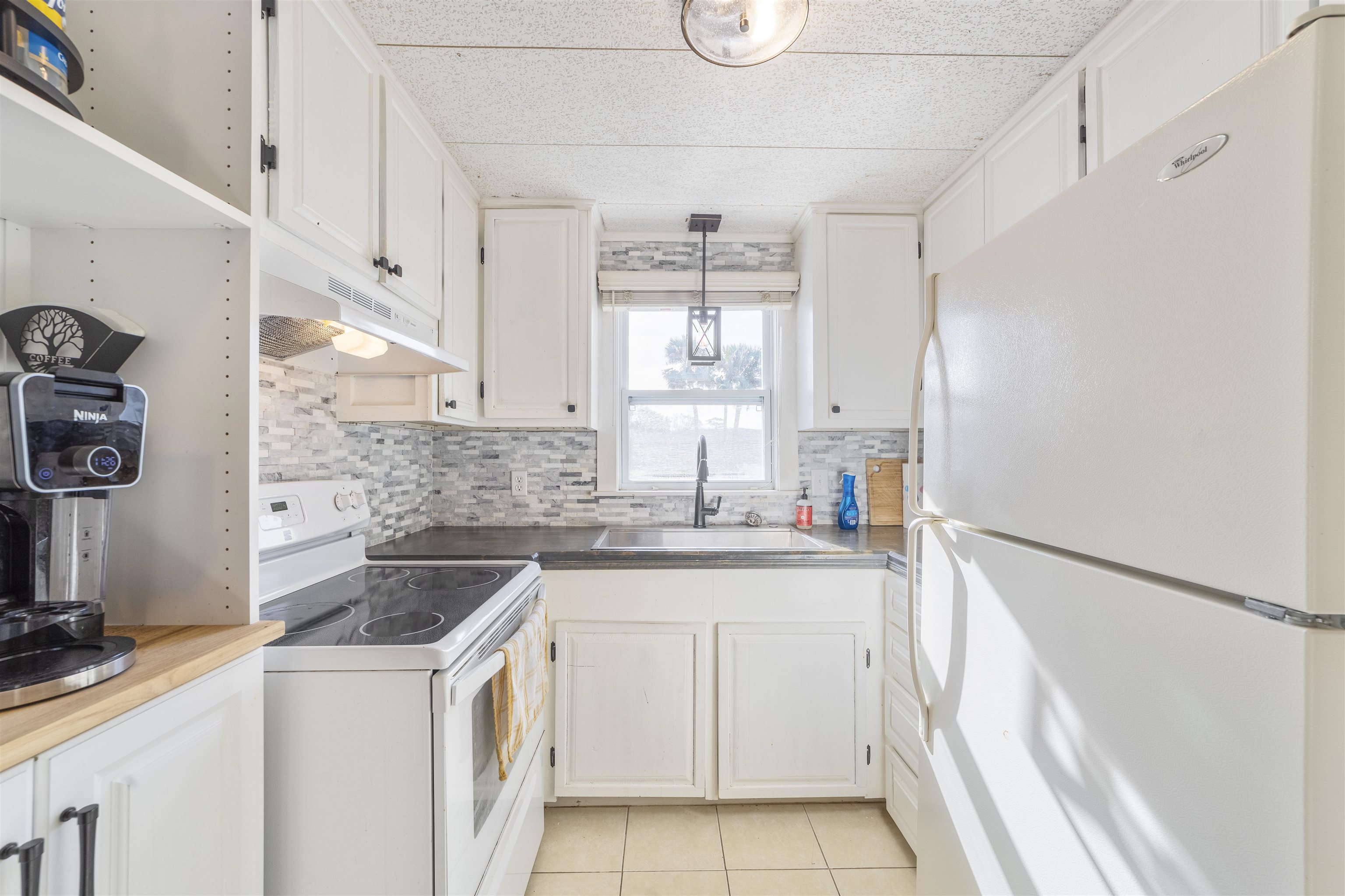 882 Palermo Road St. Augustine, FL 32086 - Photo 13 of 26 a kitchen with stainless steel appliances granite countertop a sink stove and refrigerator
