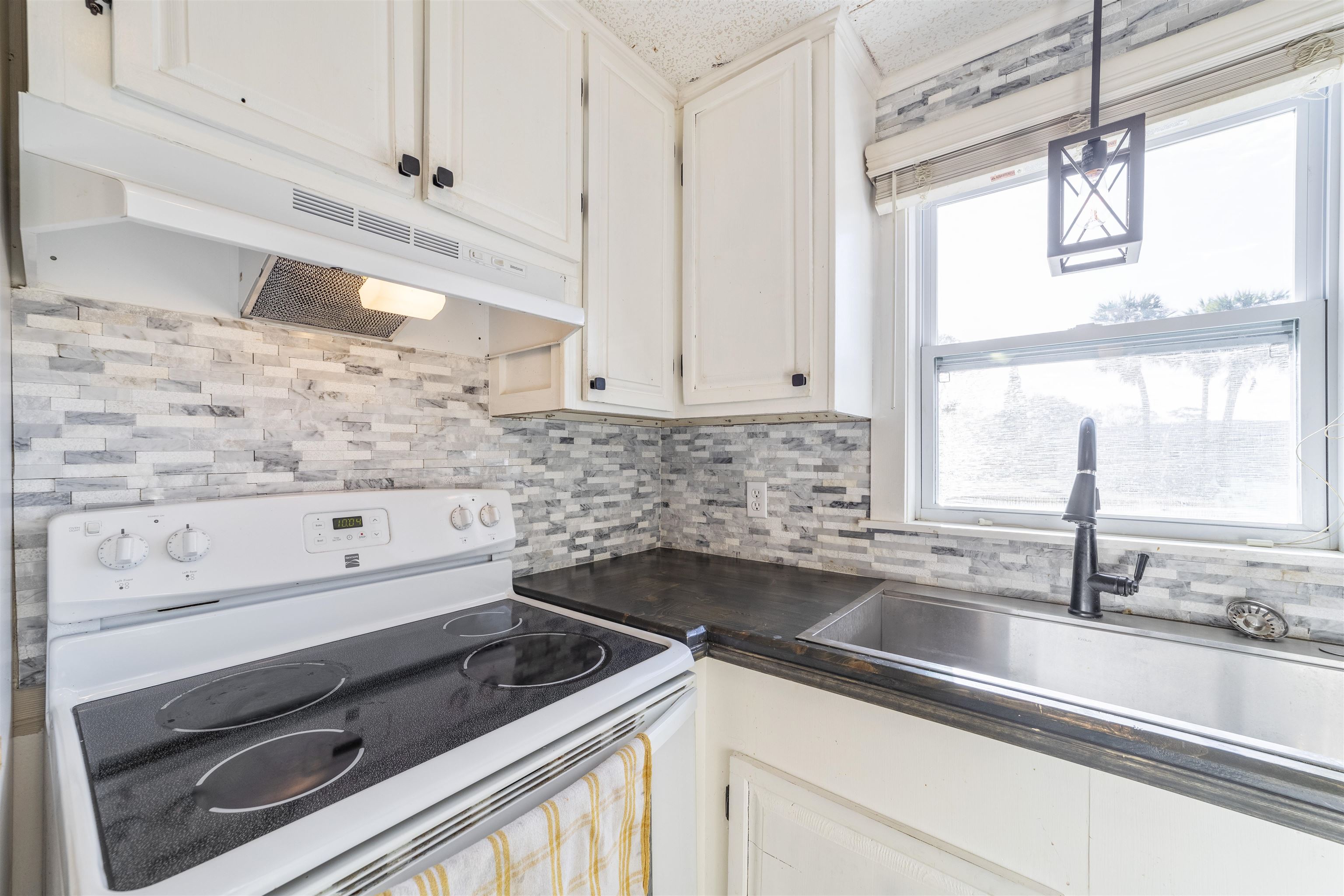 882 Palermo Road St. Augustine, FL 32086 - Photo 14 of 26 a kitchen with granite countertop white cabinets and a sink