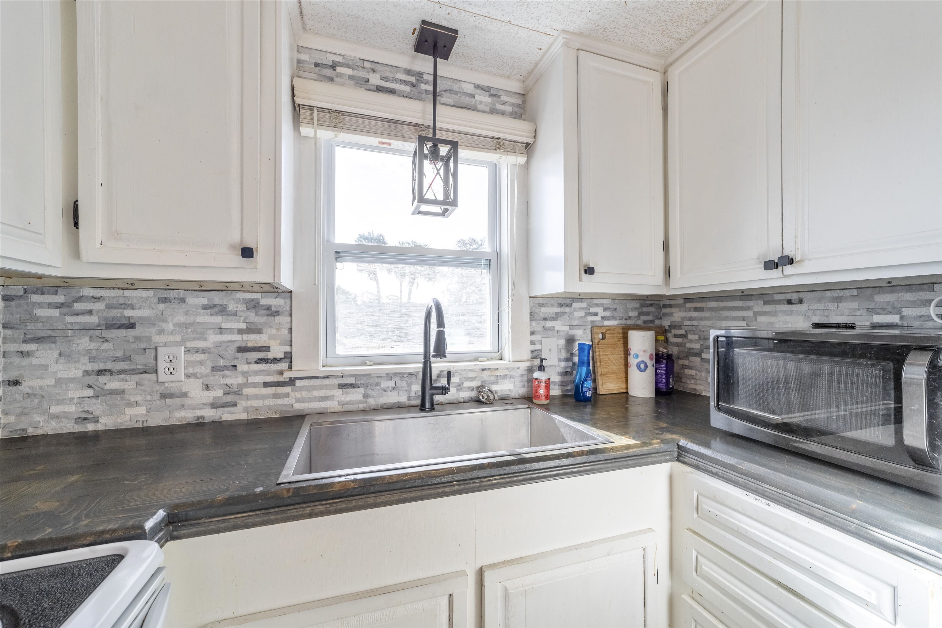 882 Palermo Road St. Augustine, FL 32086 - Photo 15 of 26 a kitchen with stainless steel appliances granite countertop a sink a stove and cabinets