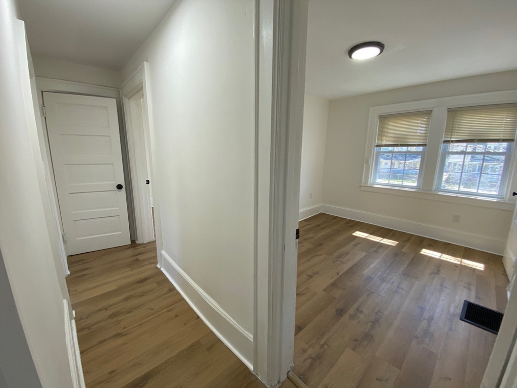 31 Freeman Terrace Springfield, MA 01104 - Photo 13 of 28 wooden floor in an empty room with a window