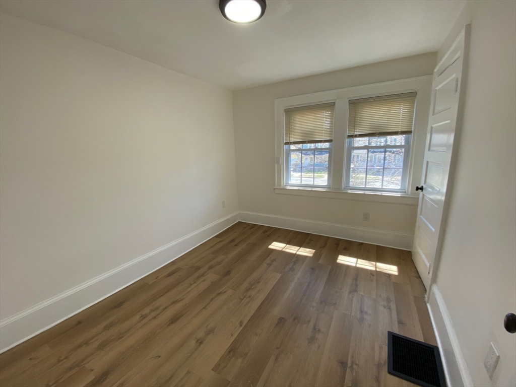 31 Freeman Terrace Springfield, MA 01104 - Photo 14 of 28 an empty room with wooden floor and windows