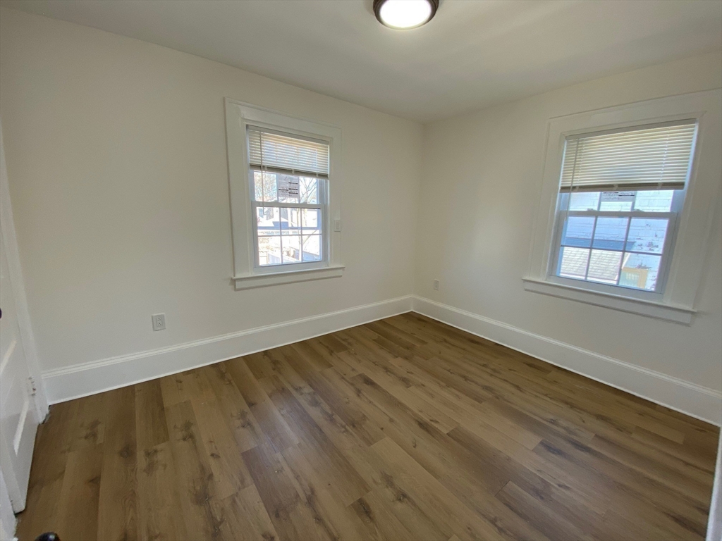 31 Freeman Terrace Springfield, MA 01104 - Photo 17 of 28 an empty room with wooden floor and windows