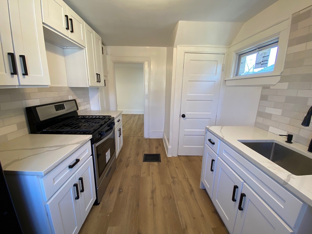 31 Freeman Terrace Springfield, MA 01104 - Photo 18 of 28 a kitchen with a sink stove and cabinets