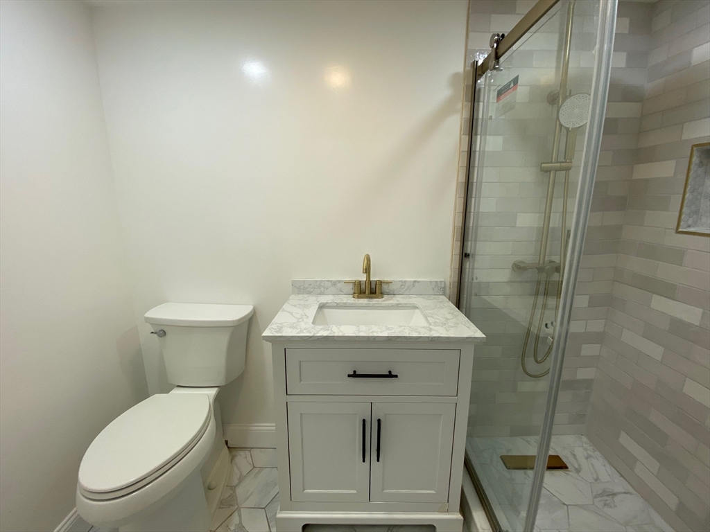 31 Freeman Terrace Springfield, MA 01104 - Photo 23 of 28 a bathroom with a sink a toilet and shower