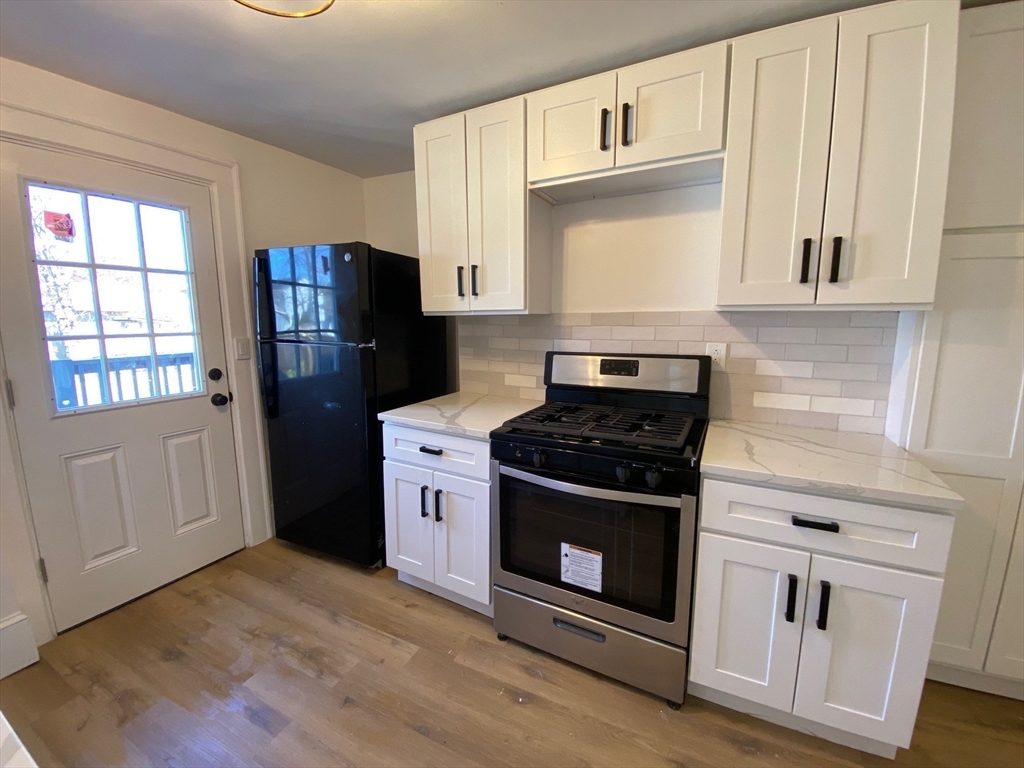 31 Freeman Terrace Springfield, MA 01104 - Photo 5 of 28 a kitchen with stainless steel appliances a stove a refrigerator and cabinets