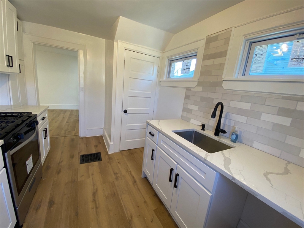 31 Freeman Terrace Springfield, MA 01104 - Photo 6 of 28 a kitchen with a sink a stove and cabinets