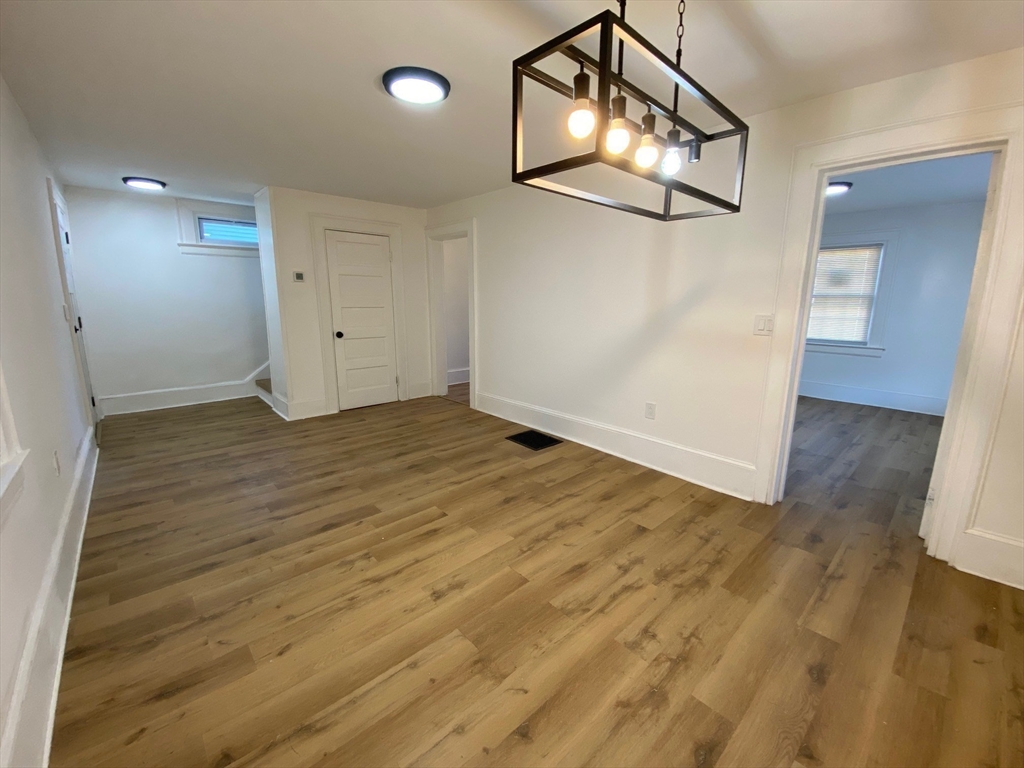31 Freeman Terrace Springfield, MA 01104 - Photo 7 of 28 an empty room with wooden floor and mirror
