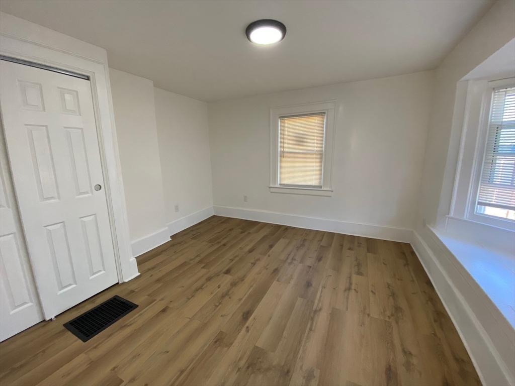 31 Freeman Terrace Springfield, MA 01104 - Photo 8 of 28 an empty room with wooden floor and windows