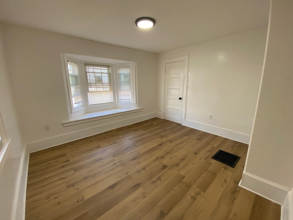 31 Freeman Terrace Springfield, MA 01104 - Photo 9 of 28 an empty room with wooden floor and windows