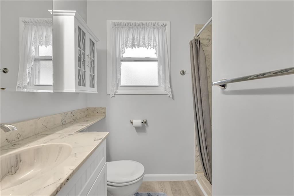 610 Davidson Drive Rochester, PA 15074 - Photo 19 of 30 a bathroom with a sink toilet and window