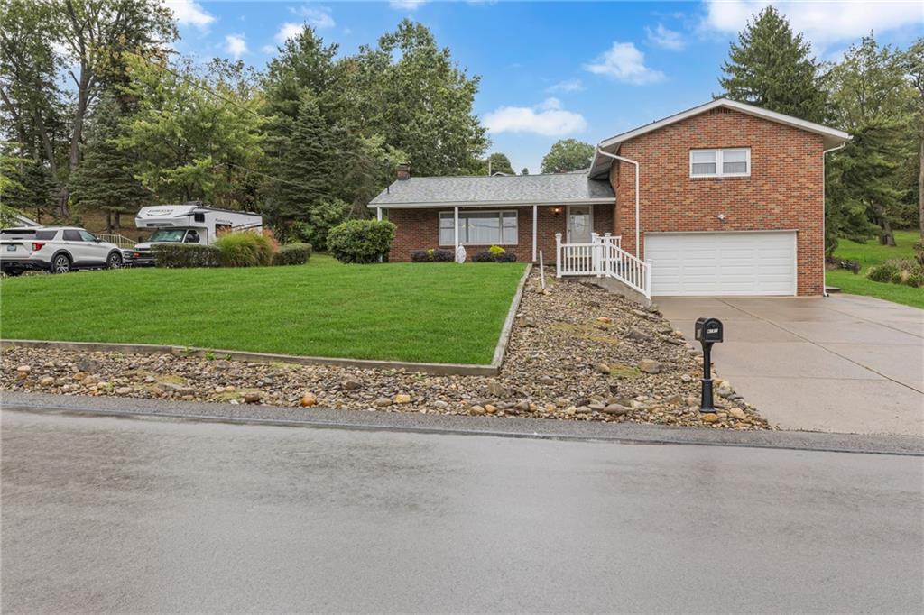 610 Davidson Drive Rochester, PA 15074 - Photo 2 of 30 a front view of a house with a yard and garage