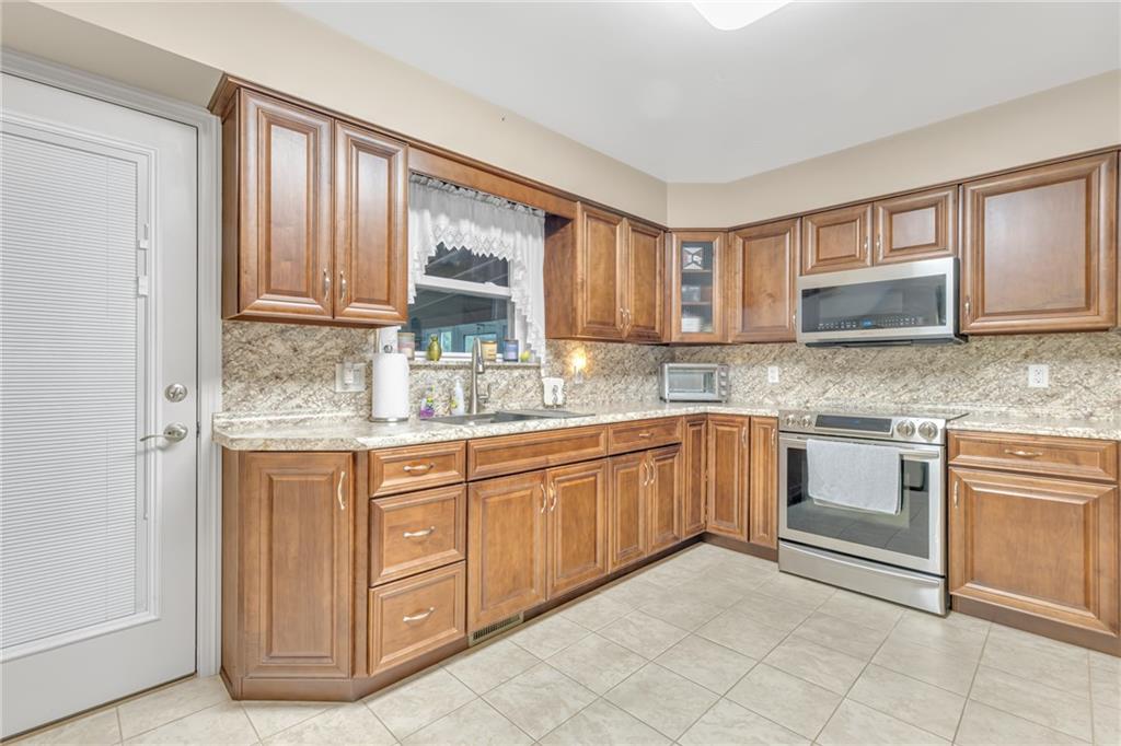 610 Davidson Drive Rochester, PA 15074 - Photo 8 of 30 a kitchen with granite countertop a sink cabinets and stainless steel appliances