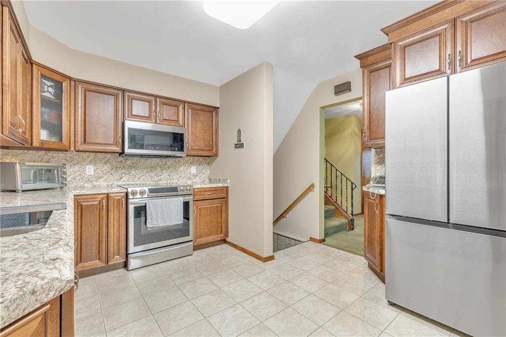 610 Davidson Drive Rochester, PA 15074 - Photo 10 of 30 a kitchen with stainless steel appliances granite countertop a refrigerator and a stove top oven