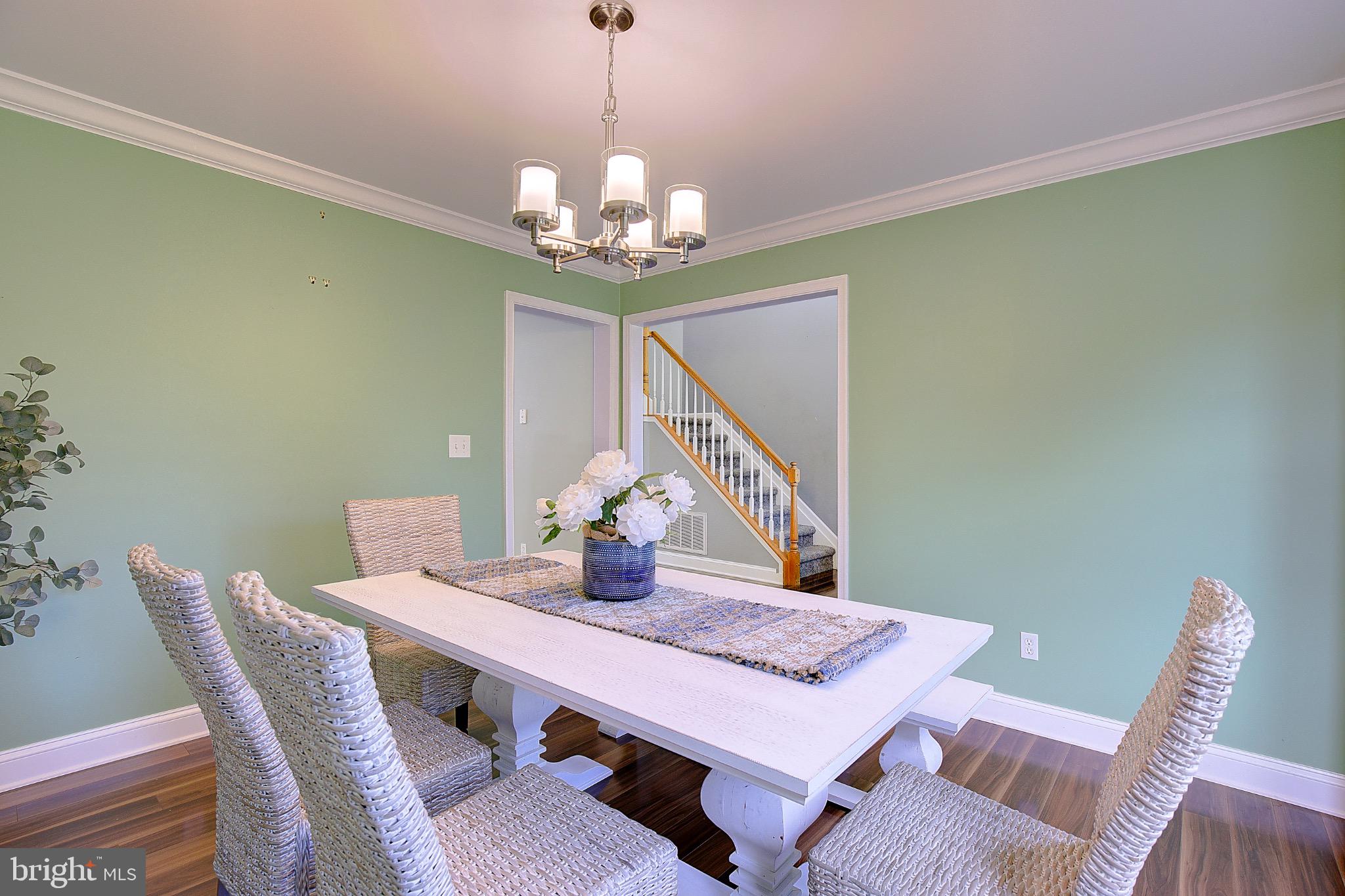 123 Bentons Pleasure Road Chester, MD 21619 - Photo 11 of 63 a view of a dining room with furniture a chandelier and window