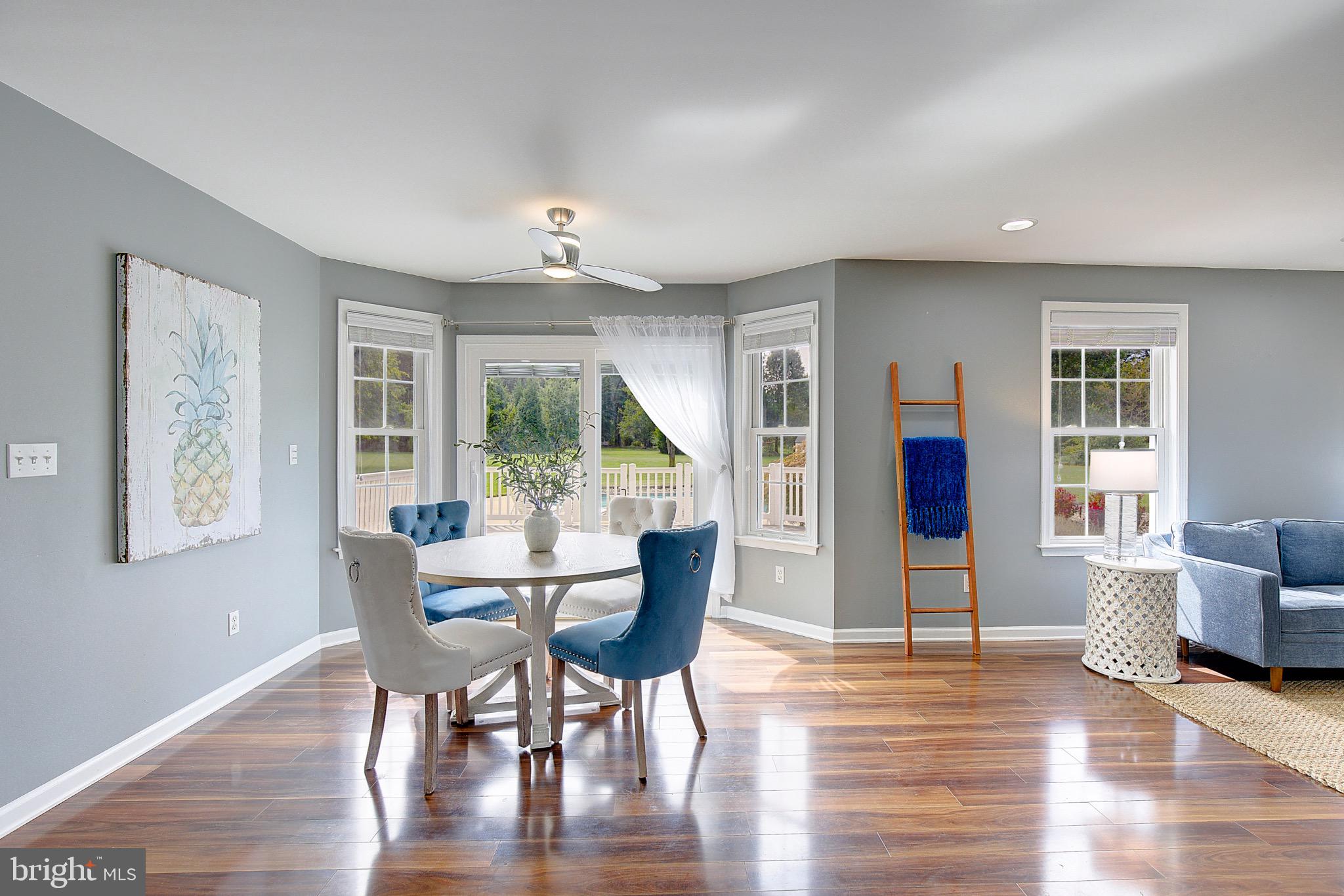123 Bentons Pleasure Road Chester, MD 21619 - Photo 18 of 63 a view of a dining room with furniture window and wooden floor