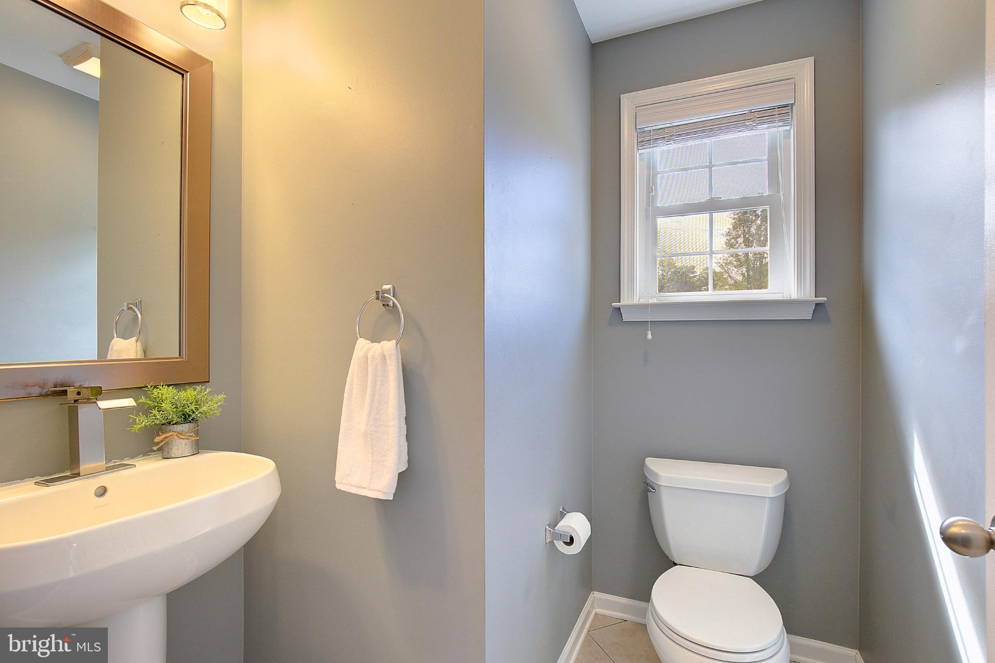 123 Bentons Pleasure Road Chester, MD 21619 - Photo 25 of 63 a bathroom with a toilet sink and mirror