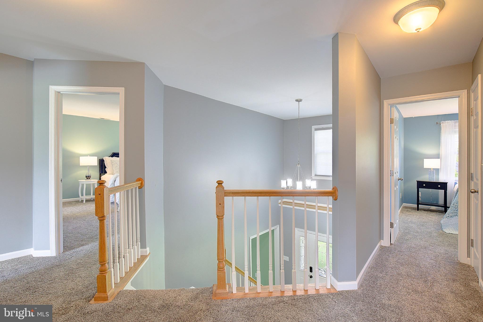 123 Bentons Pleasure Road Chester, MD 21619 - Photo 26 of 63 a view of a hallway with wooden floor and a living room
