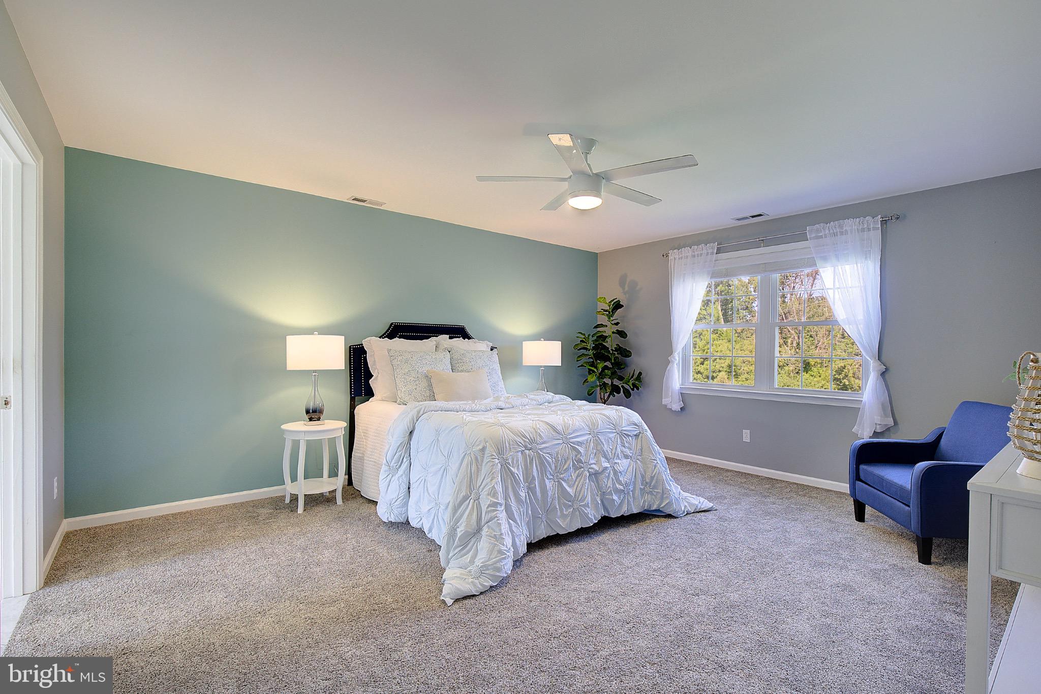 123 Bentons Pleasure Road Chester, MD 21619 - Photo 32 of 63 a bedroom with a bed and chair