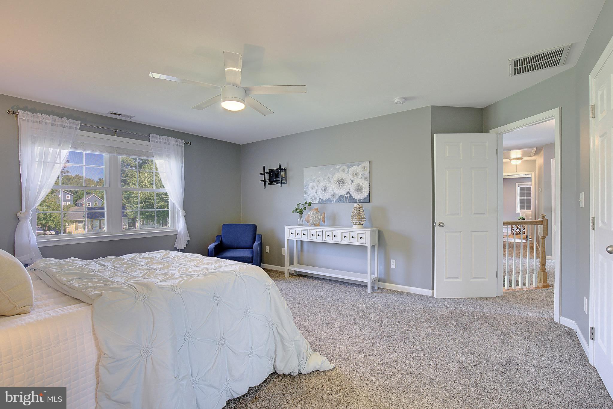 123 Bentons Pleasure Road Chester, MD 21619 - Photo 35 of 63 a bedroom with a bed and a painting on the wall