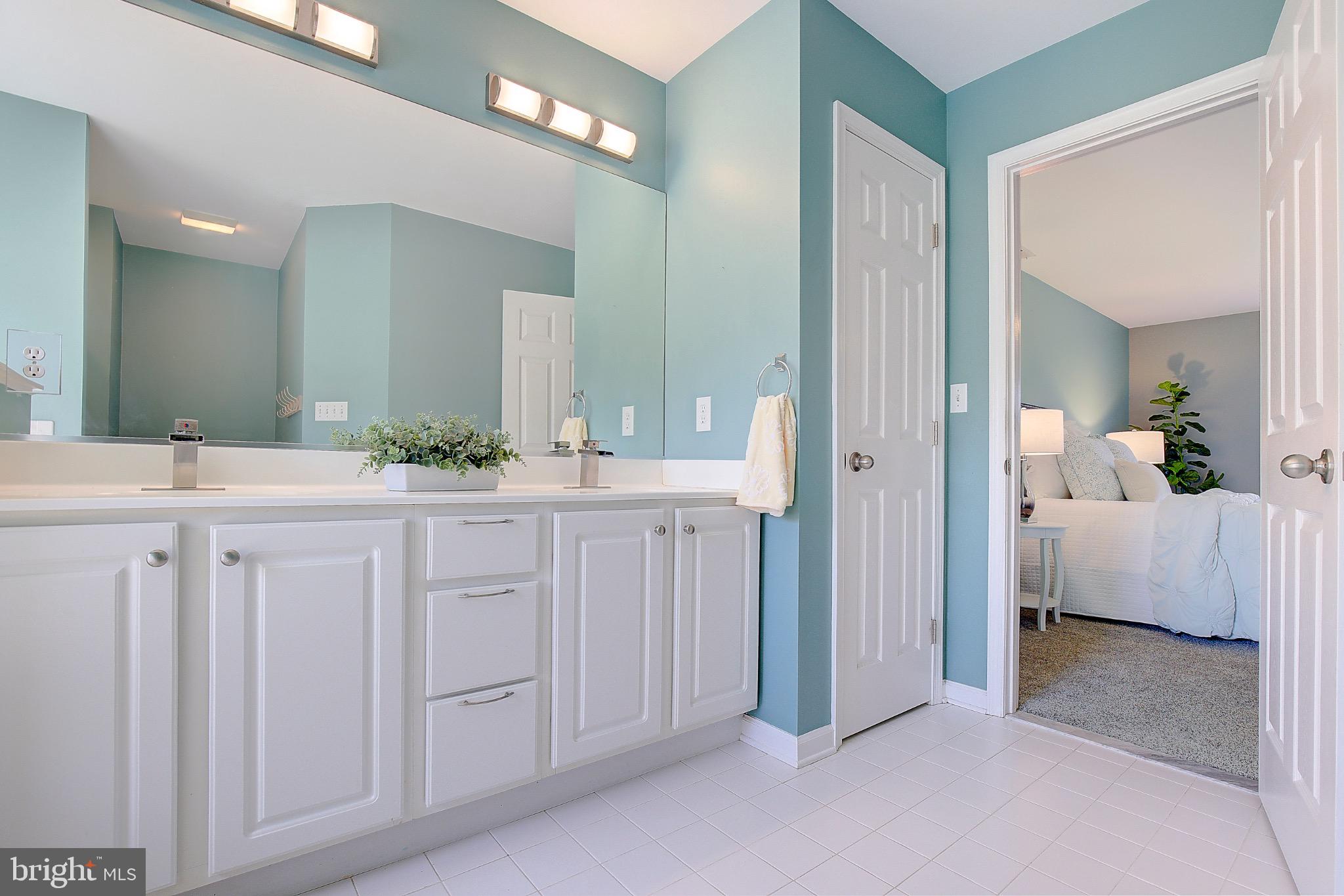 123 Bentons Pleasure Road Chester, MD 21619 - Photo 37 of 63 a spacious bathroom with a double vanity sink and mirror