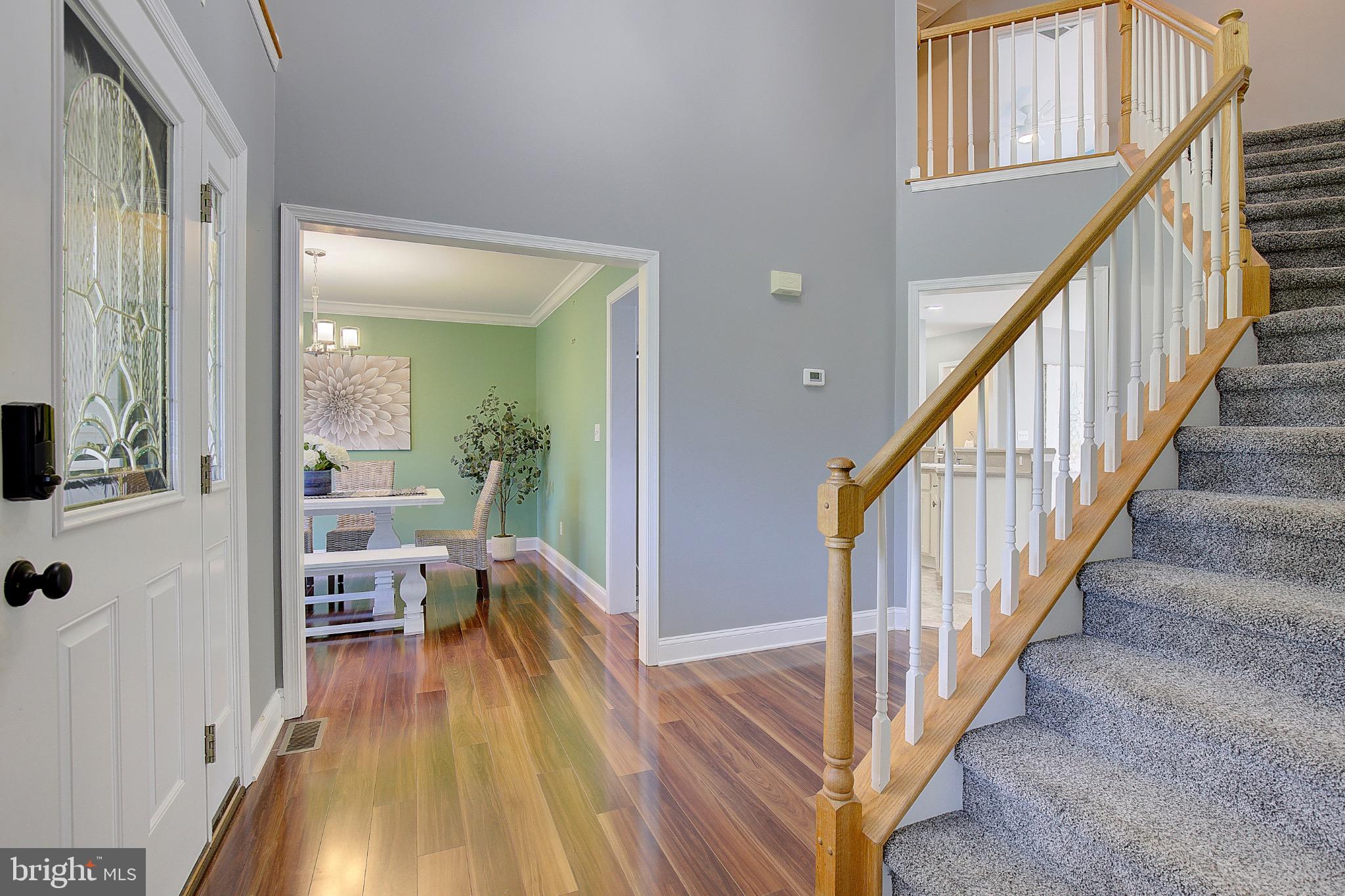 123 Bentons Pleasure Road Chester, MD 21619 - Photo 4 of 63 a view of a hallway to a livingroom with wooden floor and furniture