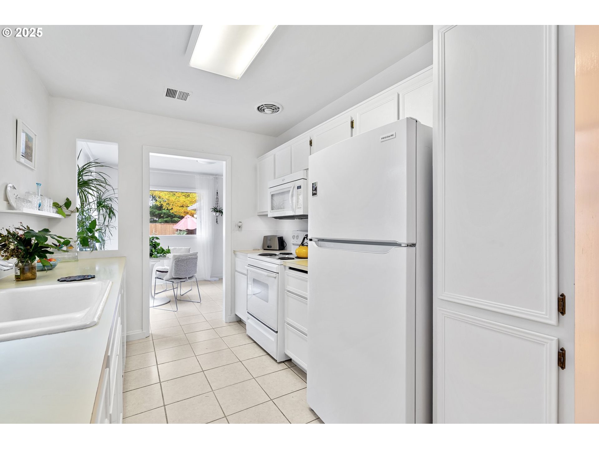 15390 Southwest Davis Road Beaverton, OR 97007 - Photo 13 of 46 a kitchen with a refrigerator a stove a washer and dryer
