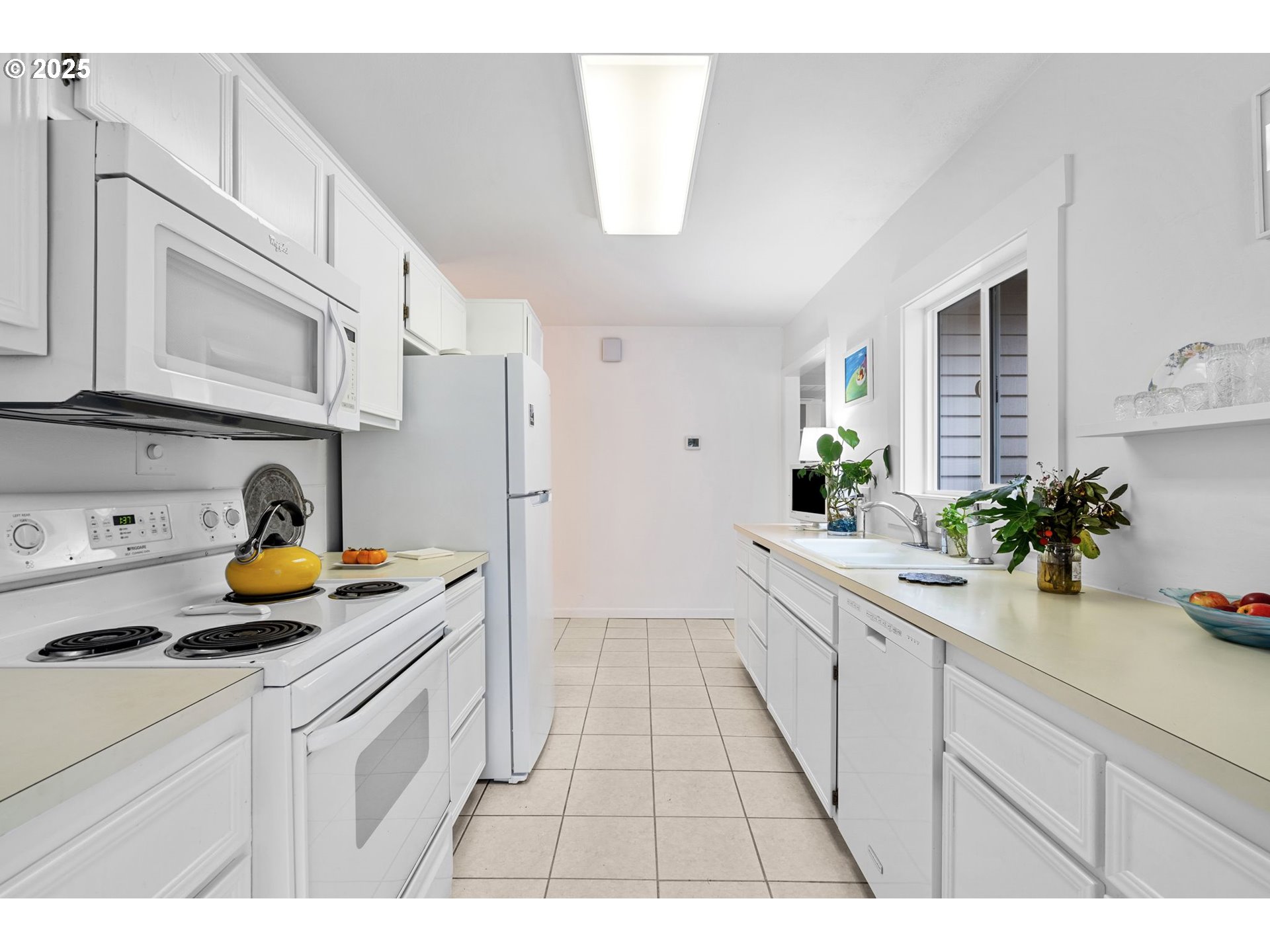 15390 Southwest Davis Road Beaverton, OR 97007 - Photo 15 of 46 a kitchen with white cabinets and appliances
