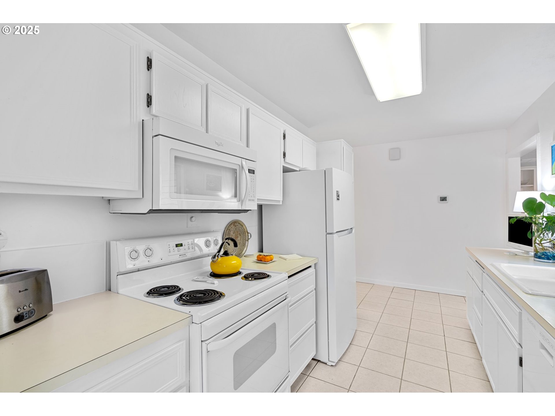 15390 Southwest Davis Road Beaverton, OR 97007 - Photo 16 of 46 a kitchen with a sink a stove and cabinets