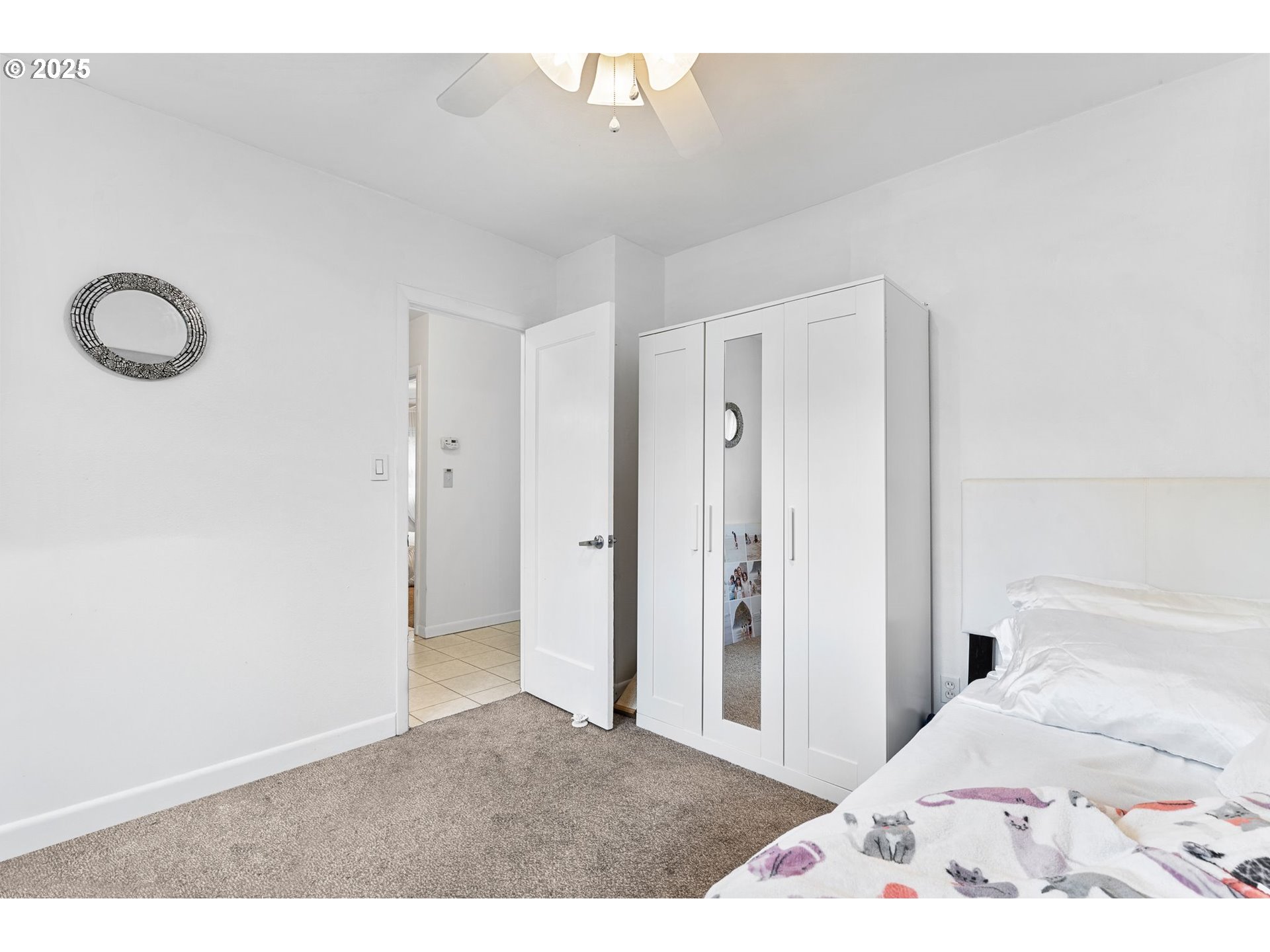 15390 Southwest Davis Road Beaverton, OR 97007 - Photo 19 of 46 a bedroom with a bed and a chandelier