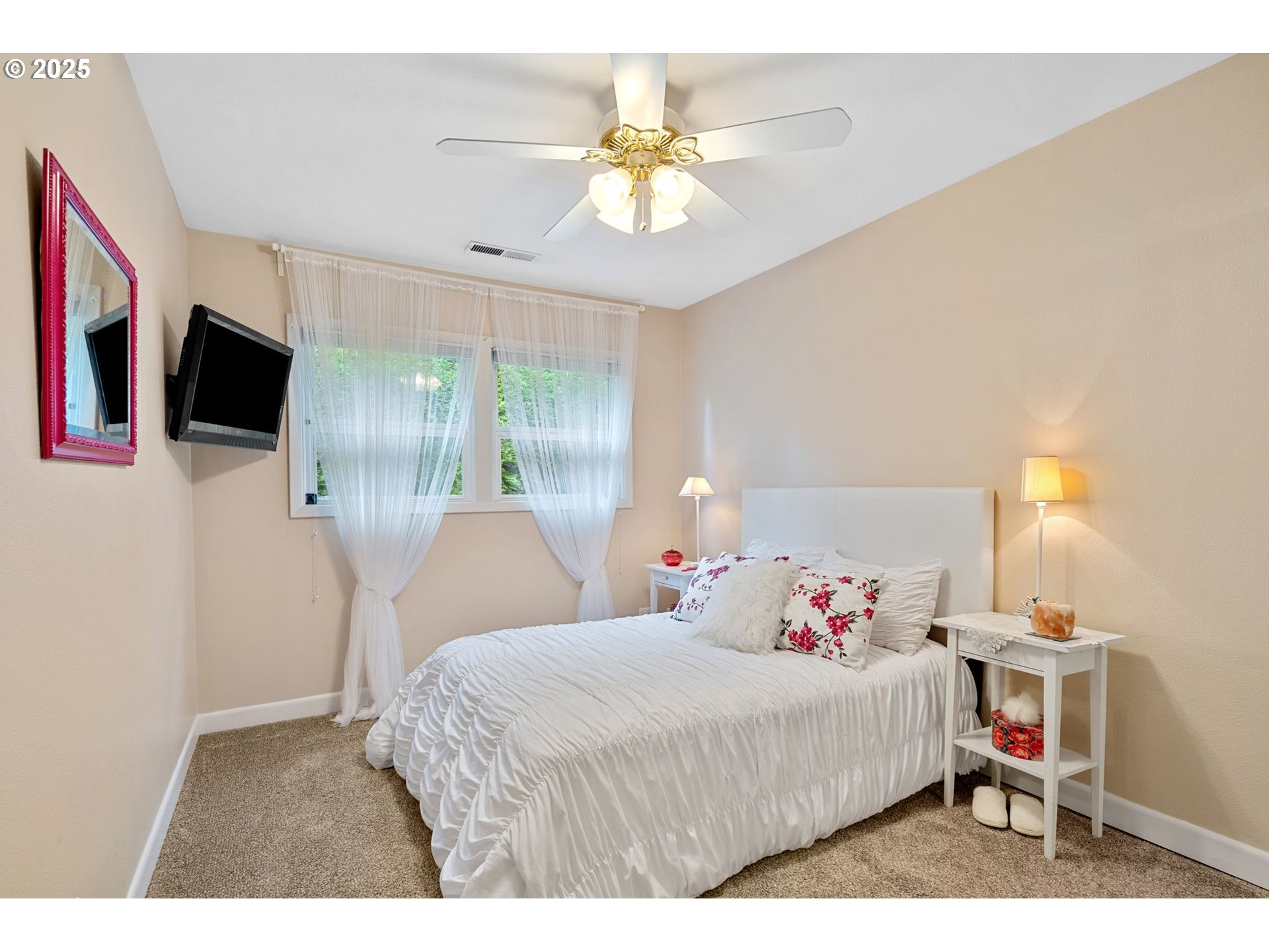15390 Southwest Davis Road Beaverton, OR 97007 - Photo 28 of 46 a bedroom with a bed a chandelier and a flat screen tv