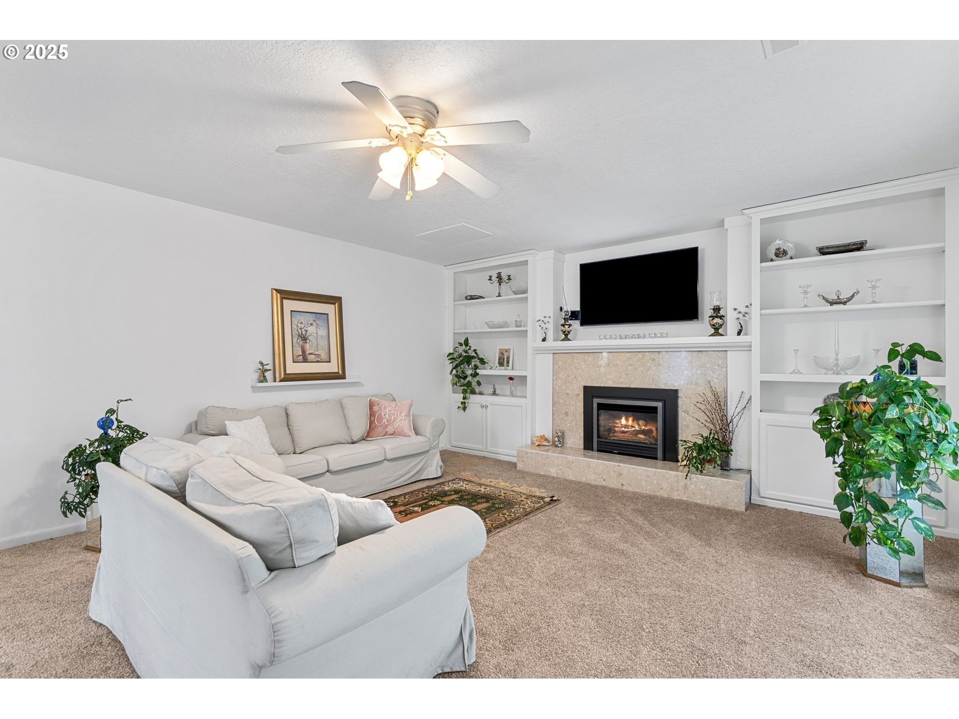 15390 Southwest Davis Road Beaverton, OR 97007 - Photo 5 of 46 a living room with furniture a fireplace and a flat screen tv