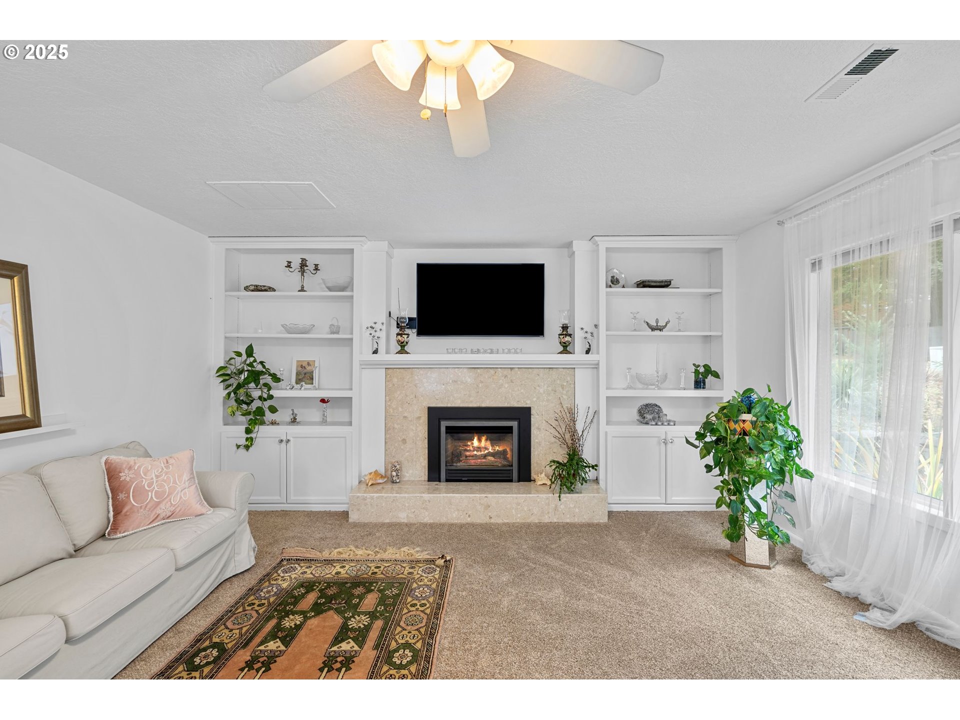 15390 Southwest Davis Road Beaverton, OR 97007 - Photo 6 of 46 a living room with furniture a fireplace and a flat screen tv