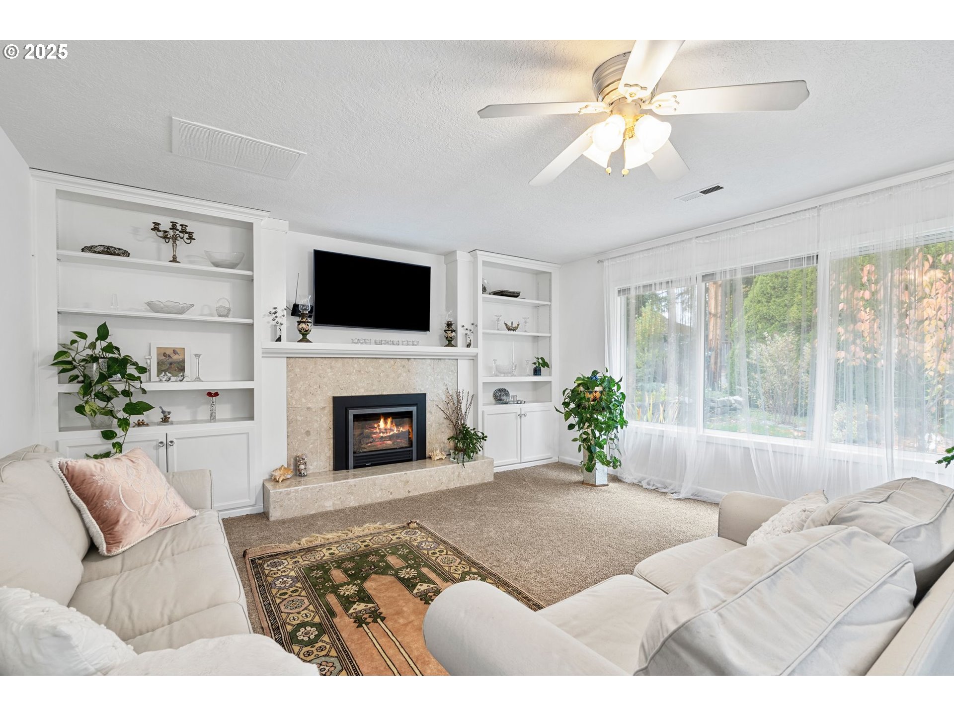 15390 Southwest Davis Road Beaverton, OR 97007 - Photo 7 of 46 a living room with furniture a fireplace and a flat screen tv