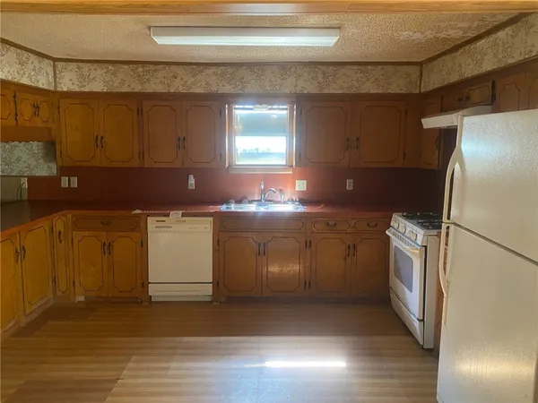 a kitchen with a sink a stove and a refrigerator