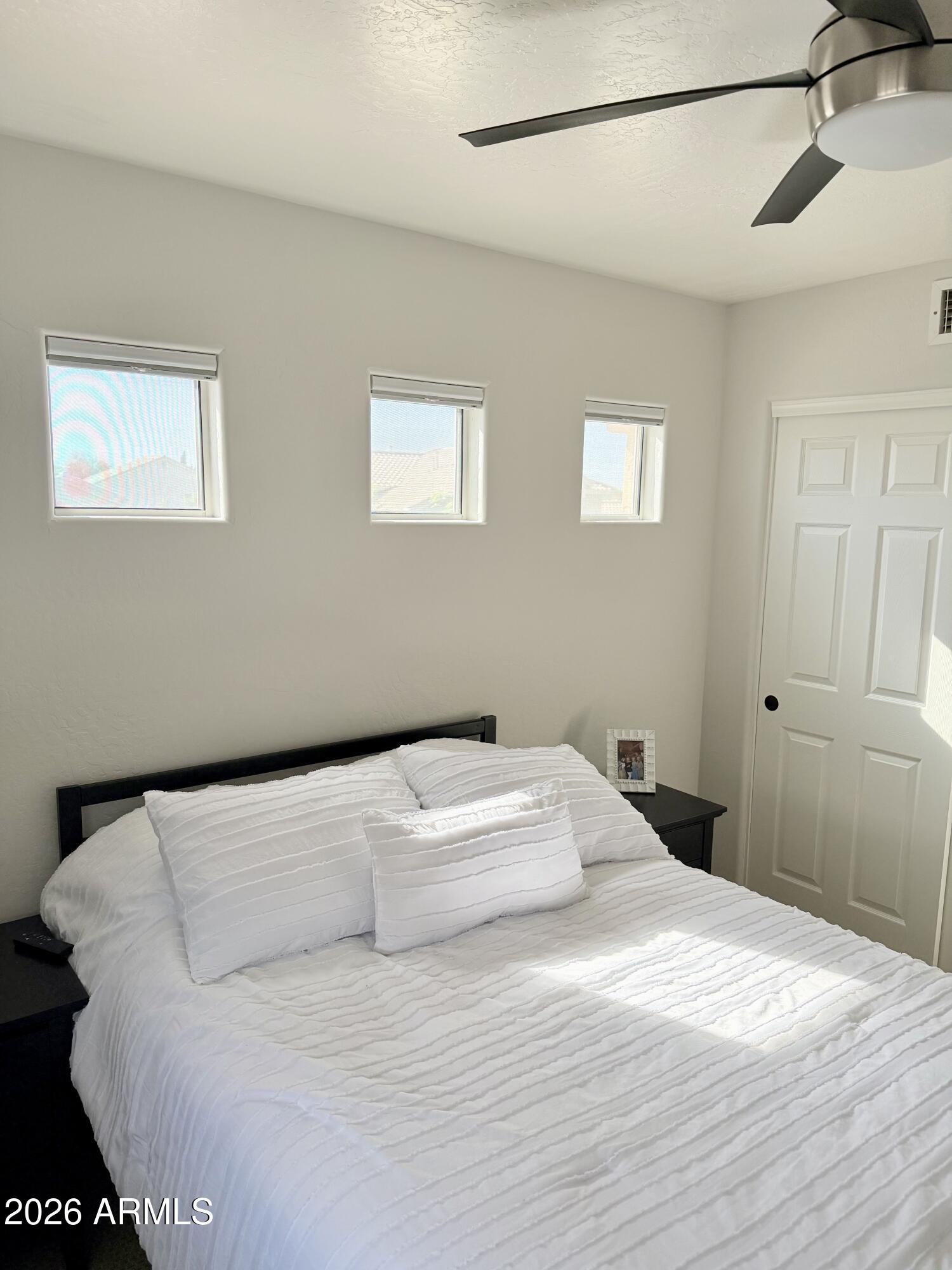 3426 East Clark Road Phoenix, AZ 85050 - Photo 35 of 48 a bedroom with a bed and a window