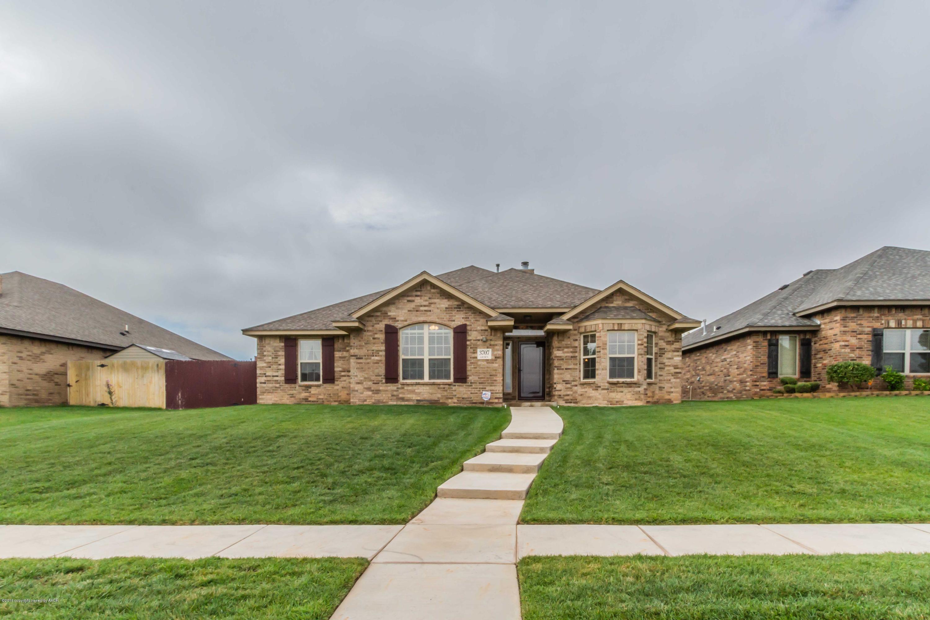 3707 Arden Road Amarillo, TX 79118 - Photo 2 of 32 a front view of a house with a yard and trees