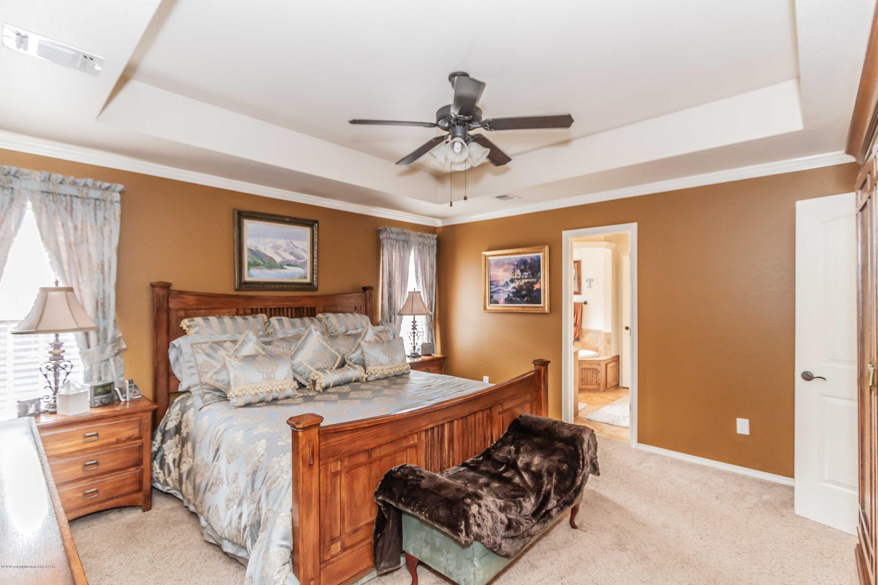 3707 Arden Road Amarillo, TX 79118 - Photo 14 of 32 a bedroom with a bed and wooden floor