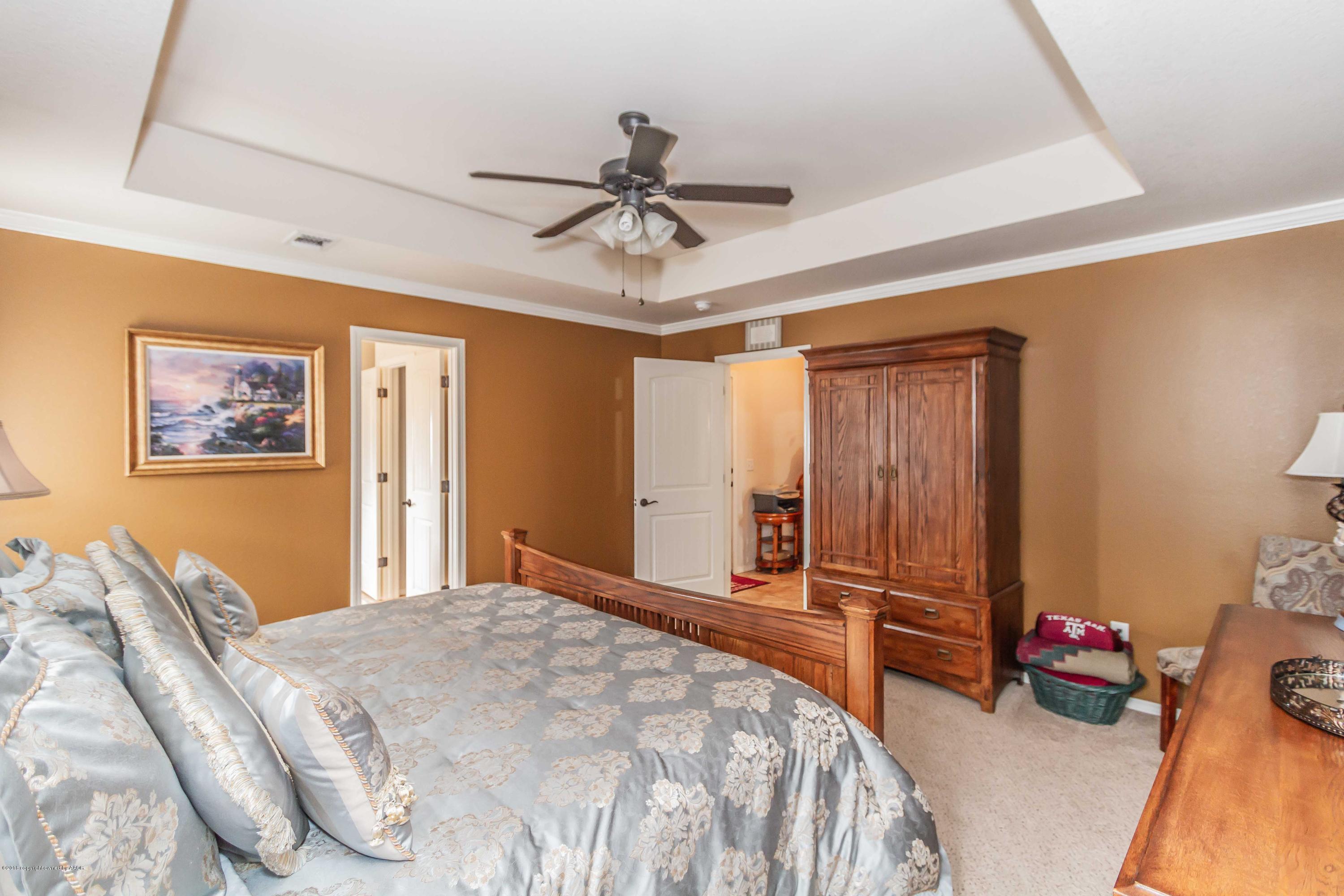 3707 Arden Road Amarillo, TX 79118 - Photo 15 of 32 a bedroom with a bed and a chandelier