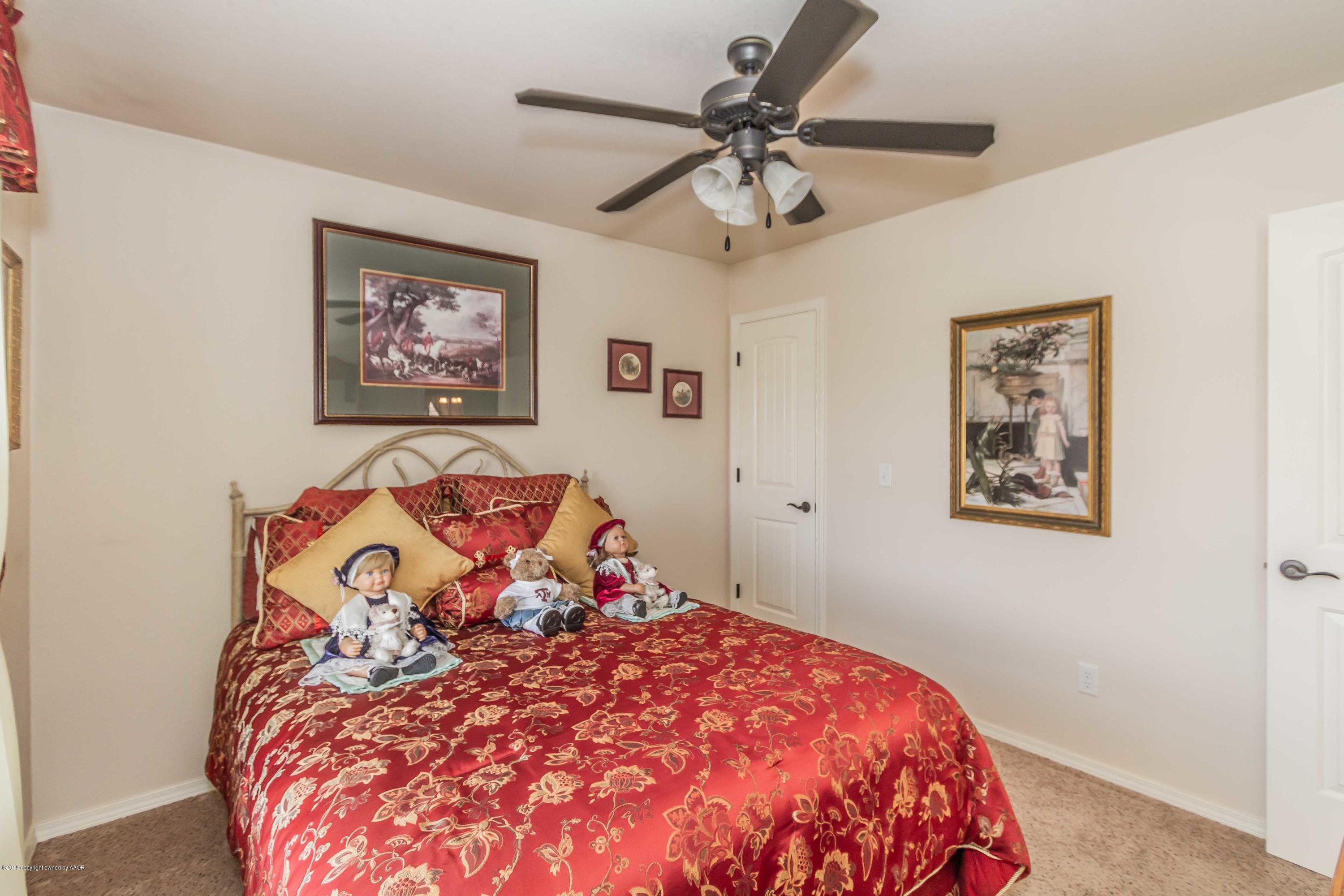 3707 Arden Road Amarillo, TX 79118 - Photo 22 of 32 a bedroom with a large bed and a chandelier