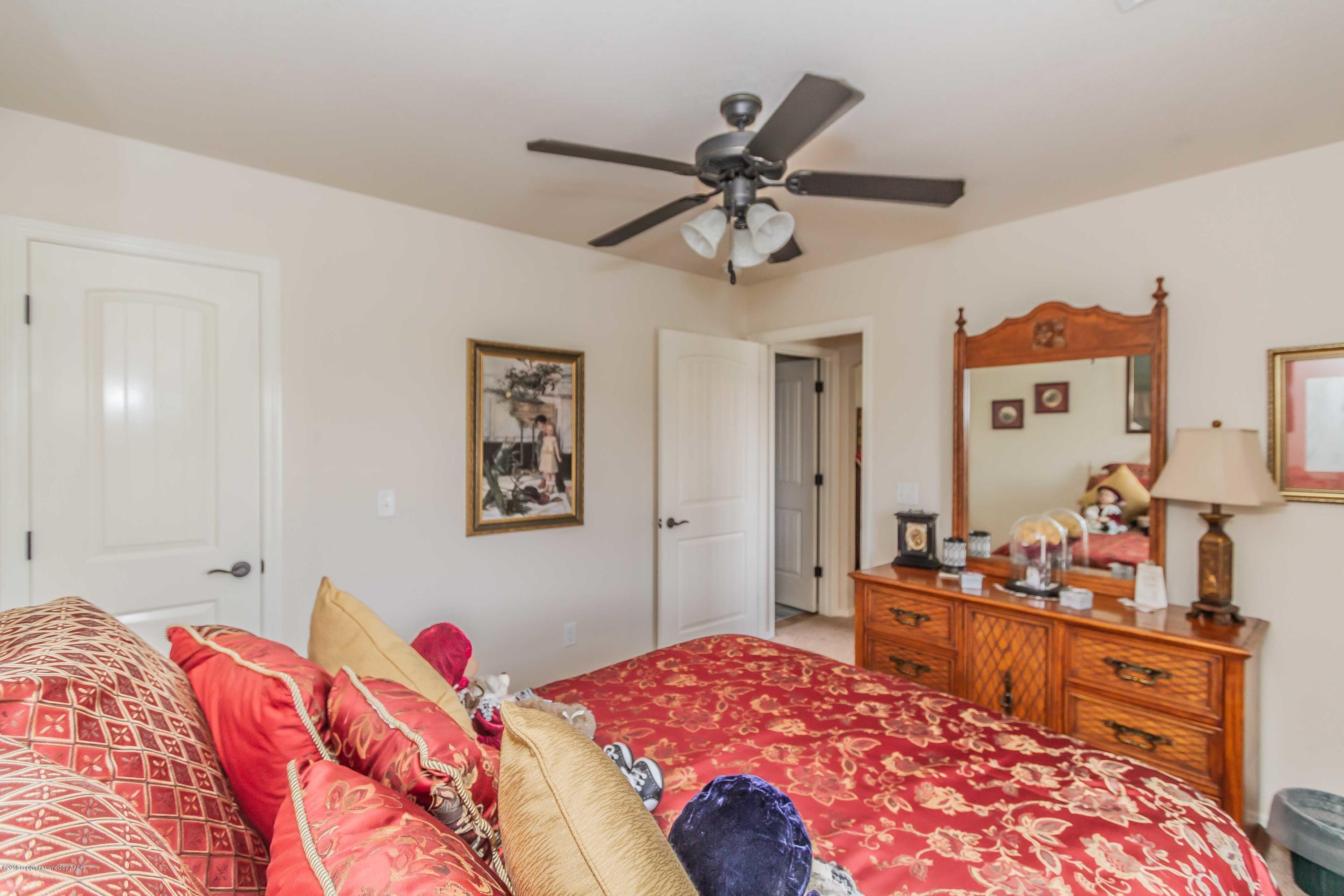 3707 Arden Road Amarillo, TX 79118 - Photo 23 of 32 a bedroom with a bed and wooden floor