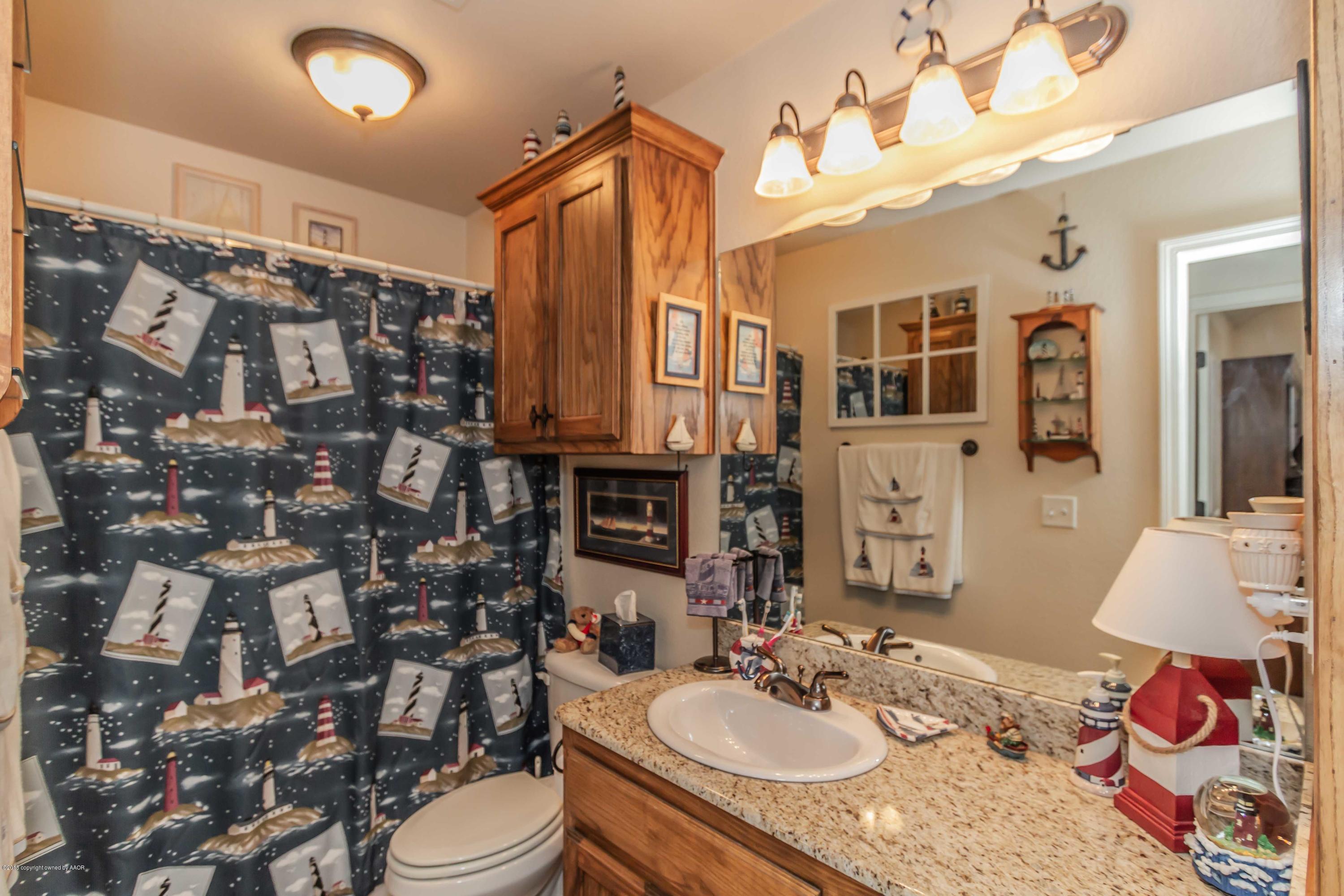 3707 Arden Road Amarillo, TX 79118 - Photo 24 of 32 a bathroom with a sink vanity granite and toilet