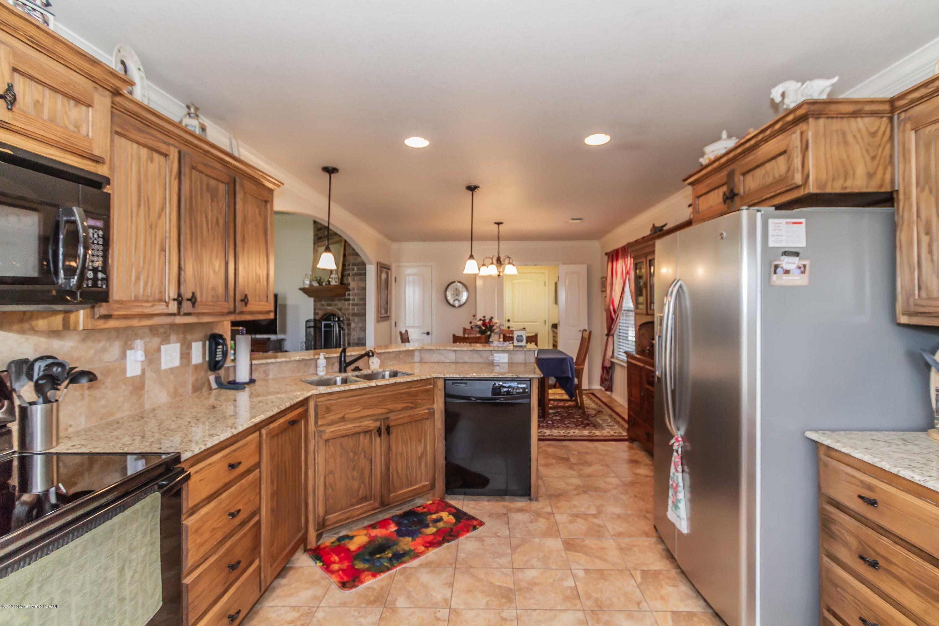3707 Arden Road Amarillo, TX 79118 - Photo 8 of 32 a kitchen with stainless steel appliances granite countertop a sink a stove and a refrigerator