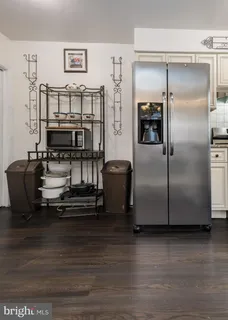 a kitchen with kitchen island a counter top space and stainless steel appliances