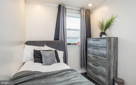 a bedroom with a large bed and a potted plant