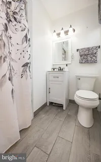 wooden floor in closet with white walls