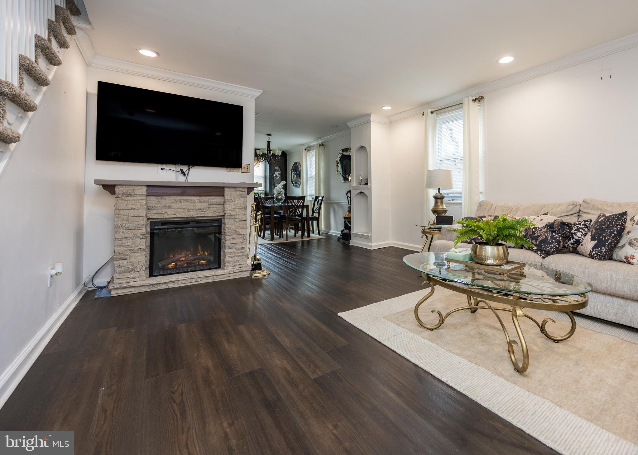 800 Disston Street Philadelphia, PA 19111 - Photo 6 of 51 a living room with furniture a flat screen tv and a fireplace